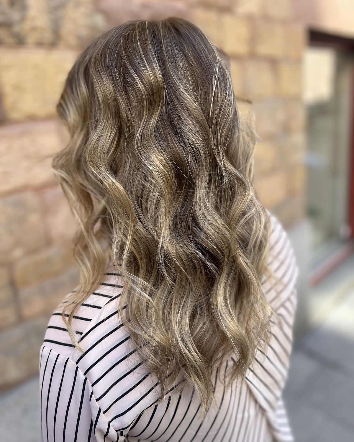 Balayage with soft waves in light and dark blonde tones